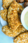 a plate of air fryer chicken tenders with dipping sauce
