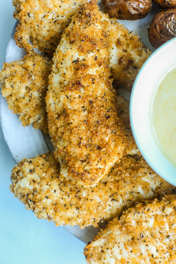a plate of air fryer chicken tenders with dipping sauce