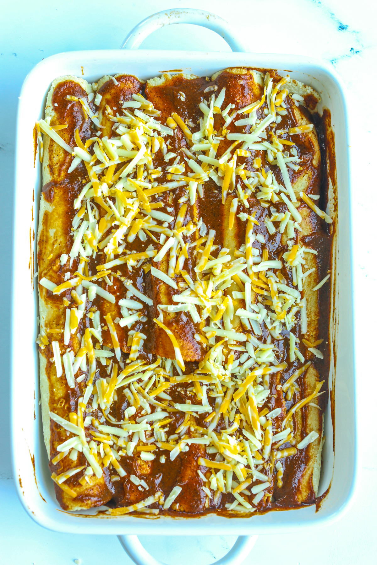 chicken enchiladas in a pan before baking 