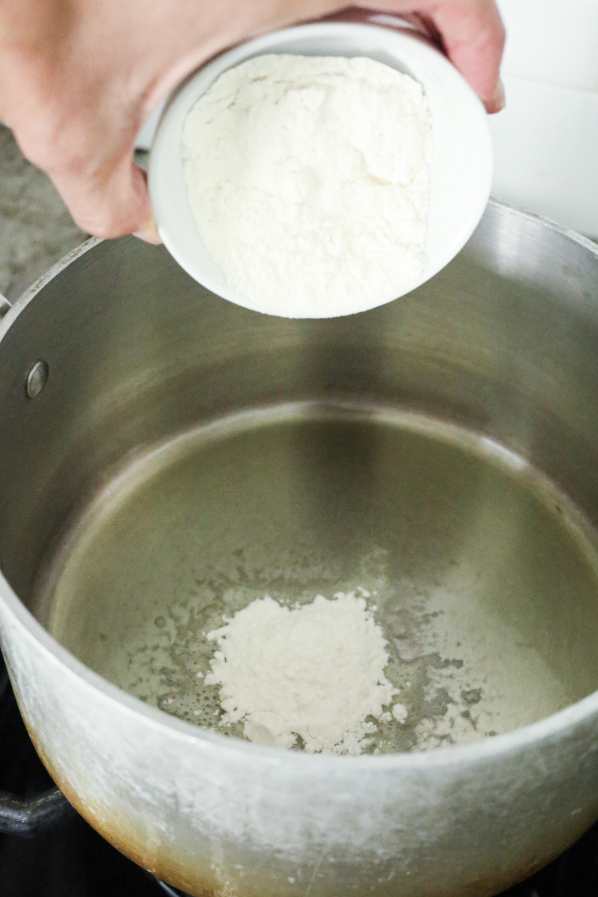 oil in a pan with flour being added