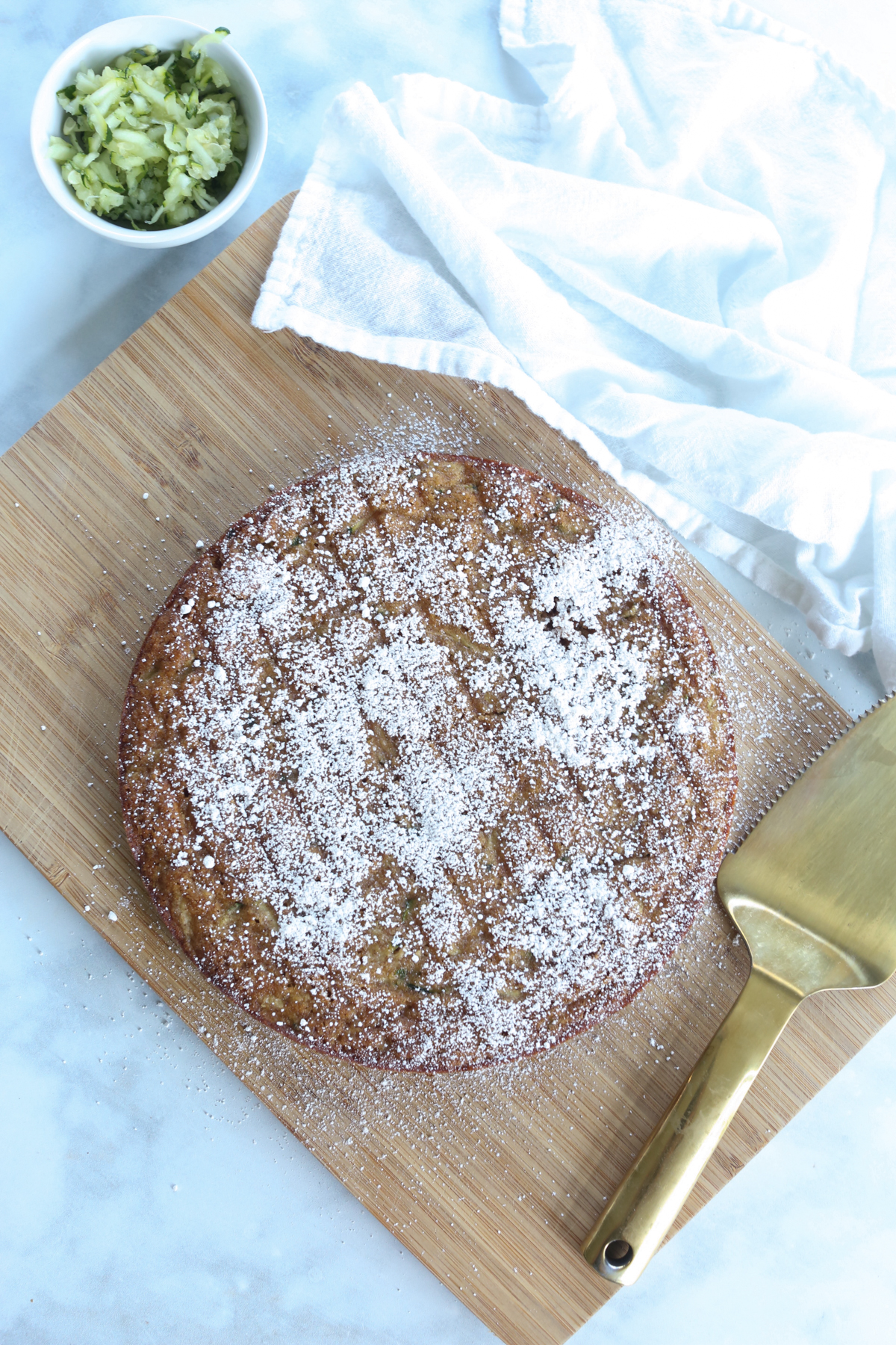 a whole anti-inflammatory zucchini cake on a cutting board