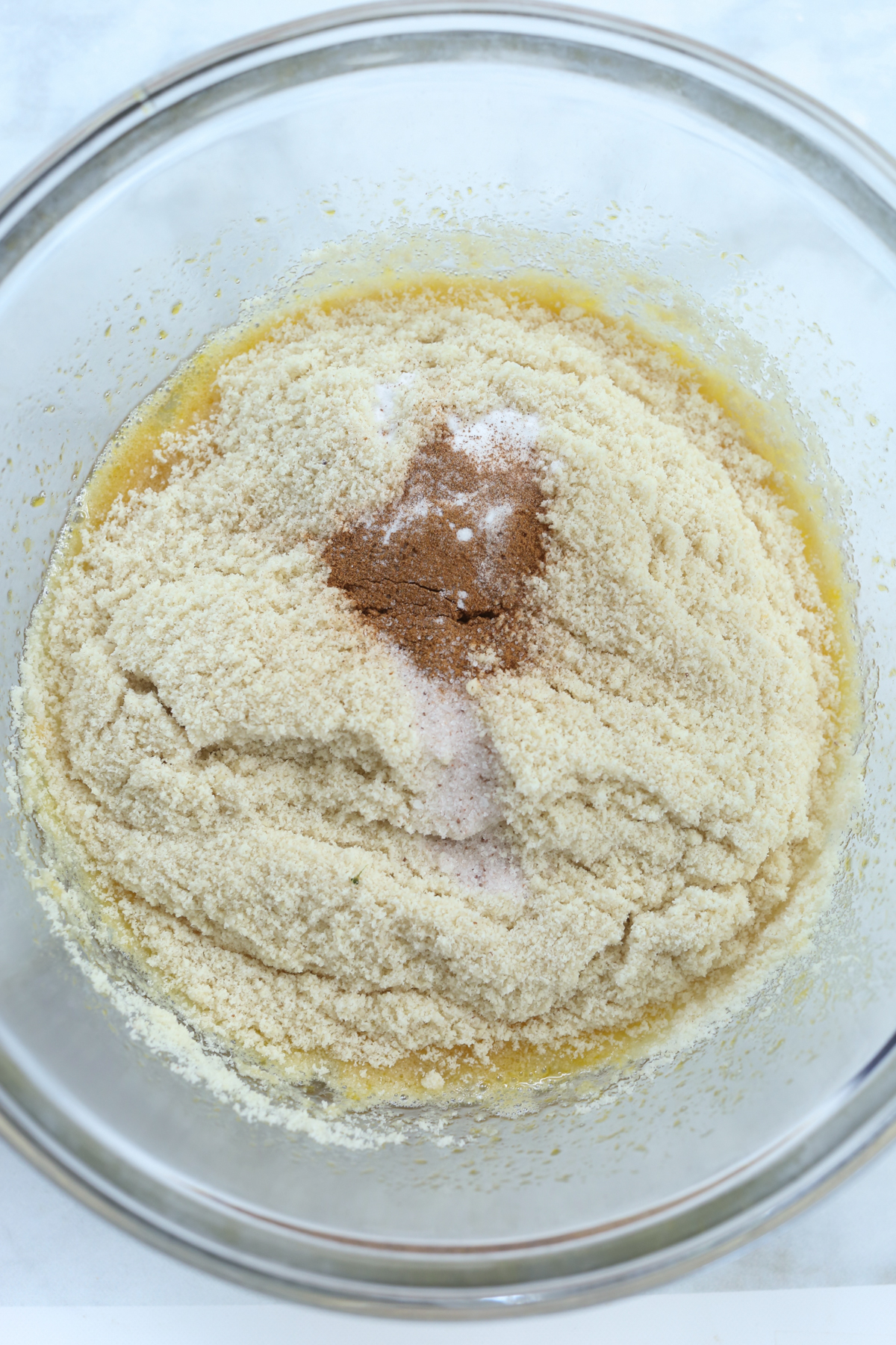 adding dry ingredients to wet ingredients in a bowl