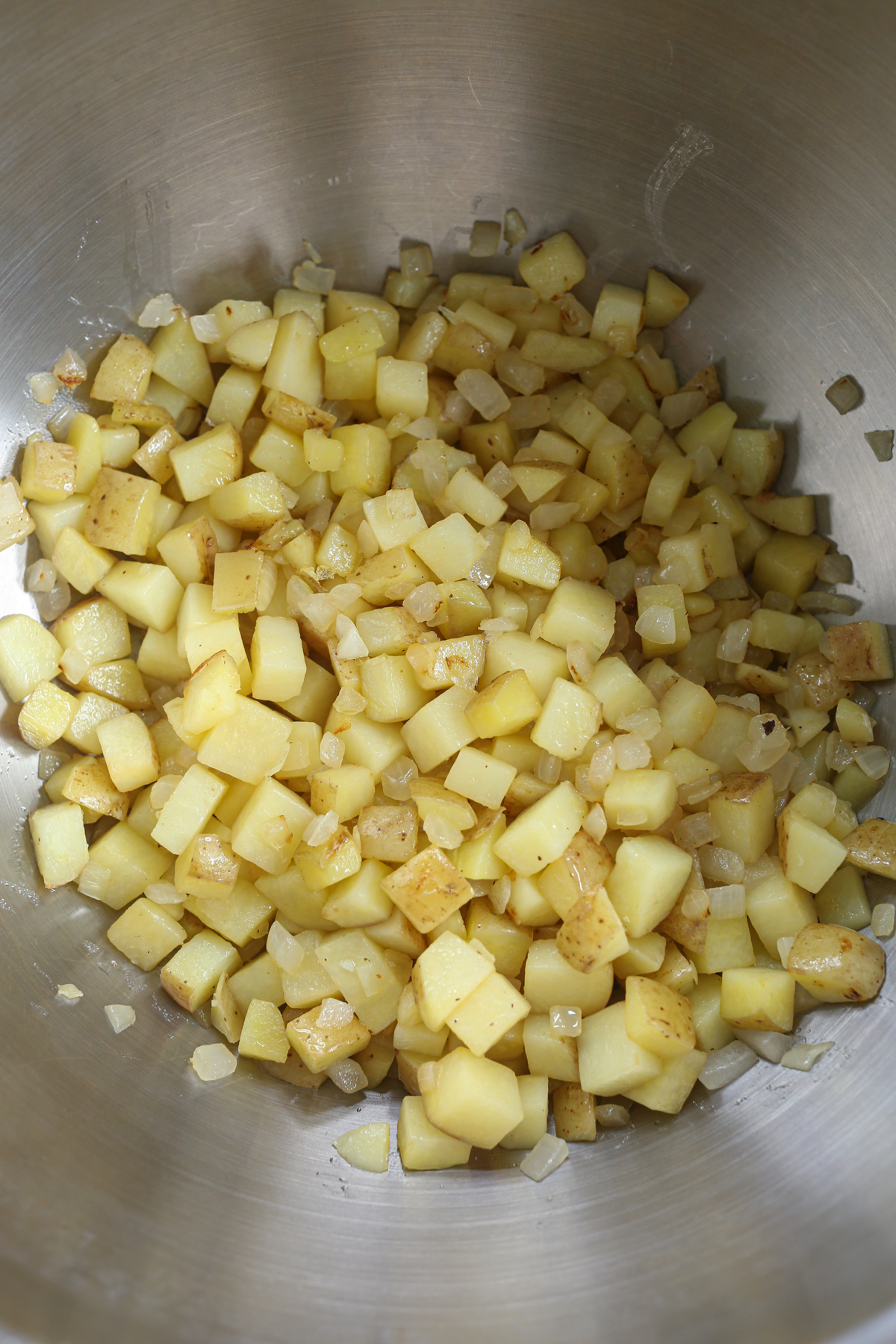 cooked potatoes and onion in a large bowl