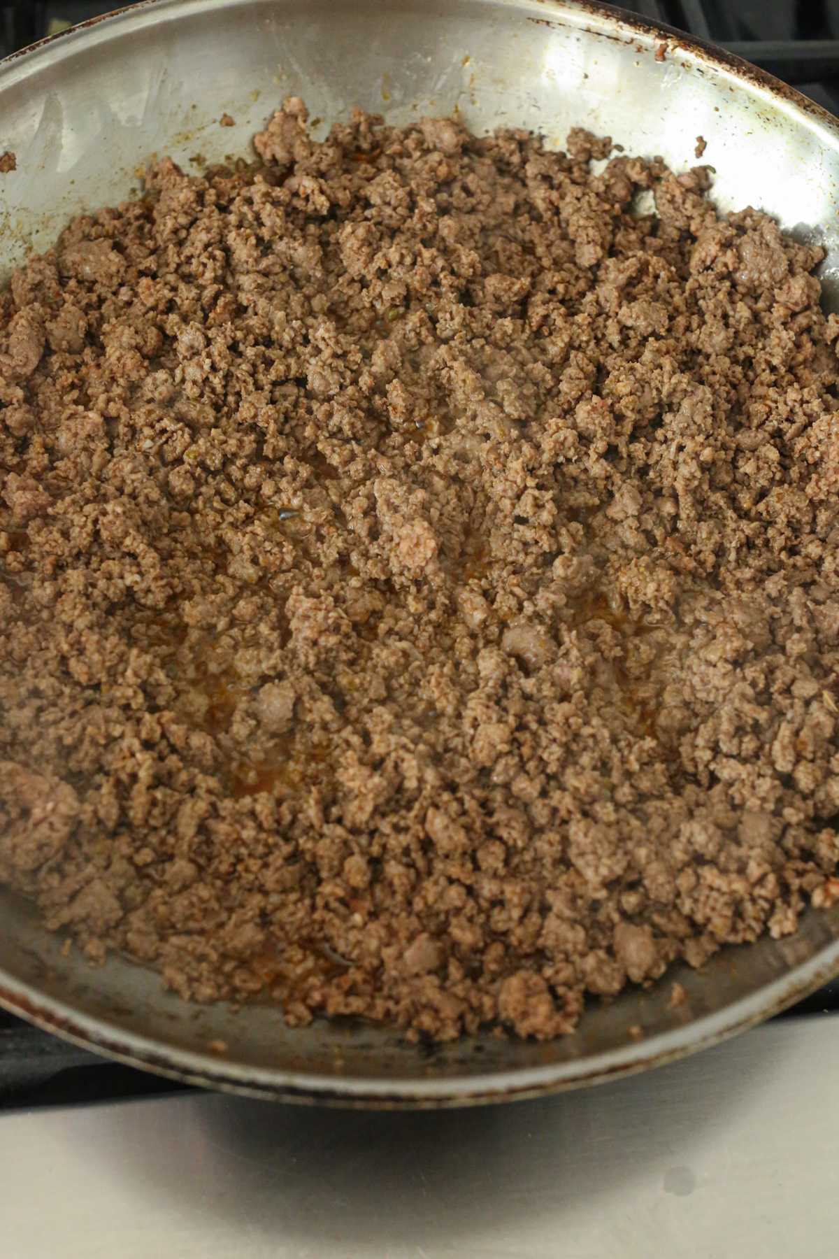 ground beef browning in a pan
